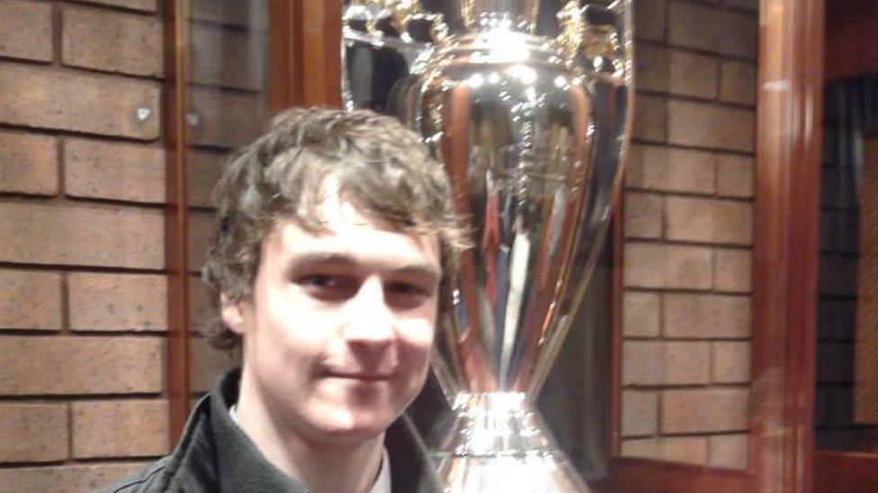 Mark with the Premier League trophy.