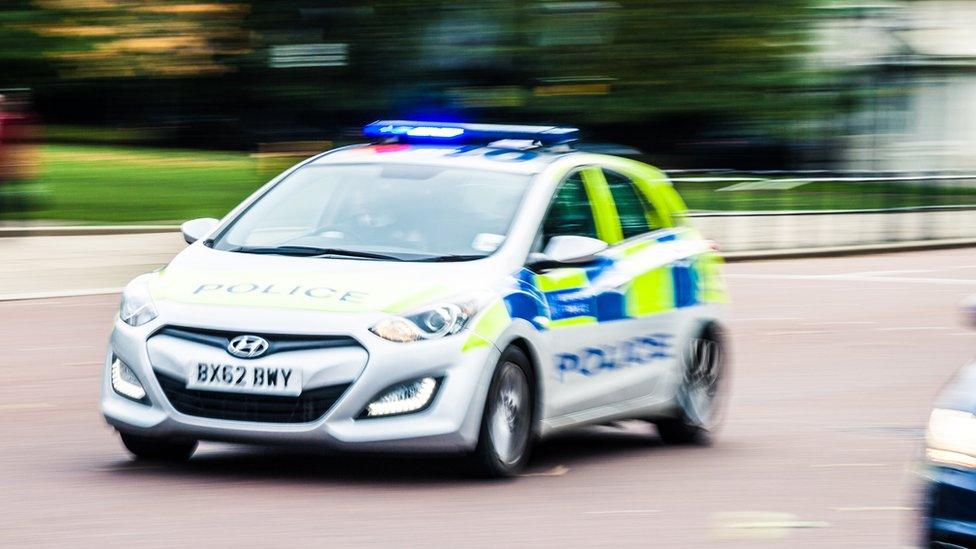 A police car responding to an emergency in London