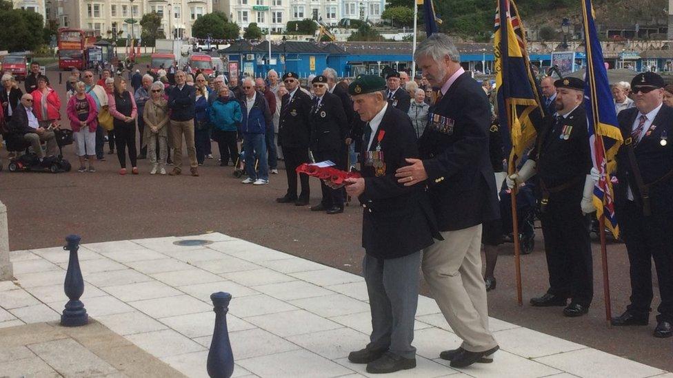 Ronald Thorpe yn gosod torch ar gofeb rhyfel Llandudno