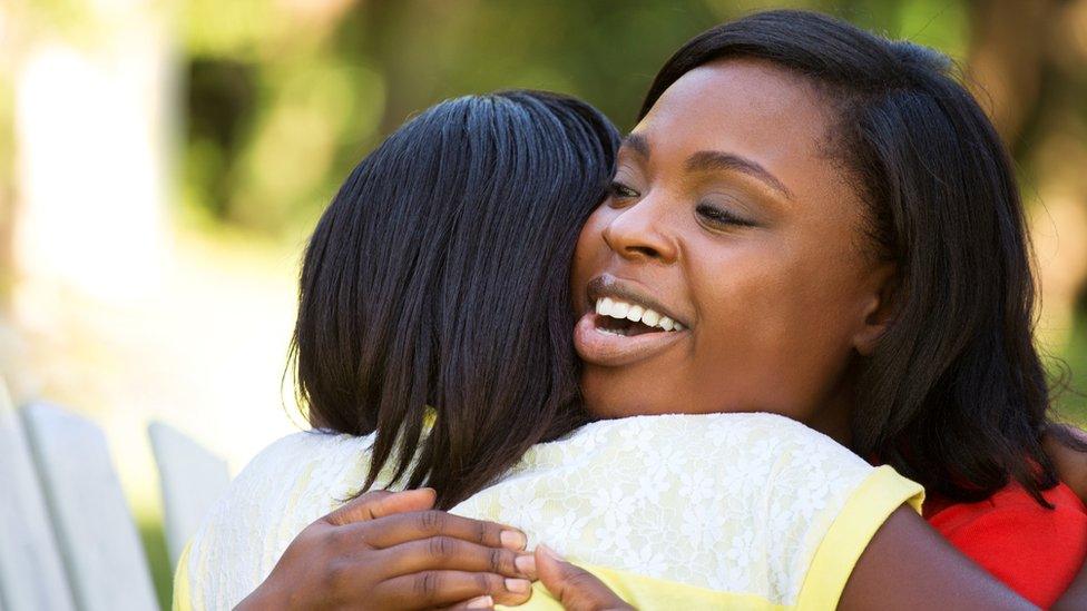 Woman hugs girl