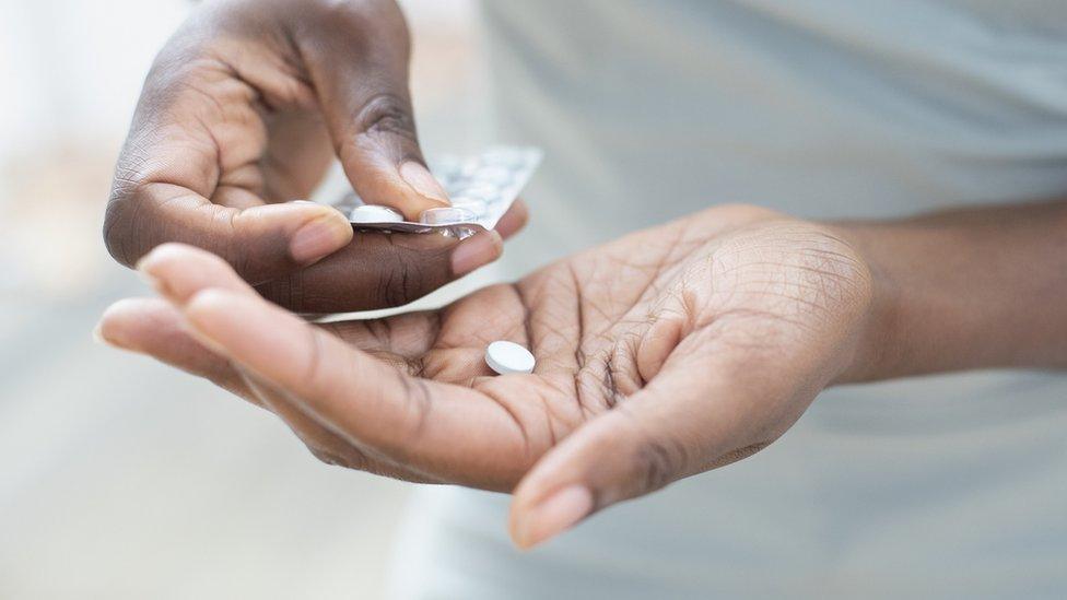 Pill being taken out of blister pack