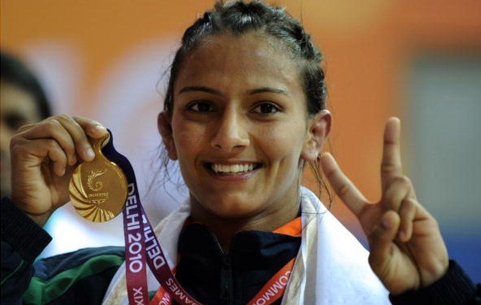 India's Geeta celebrates with her gold medal after defeating Australia's Emily Bensted in the women's wrestling 55 kg final at the XIX Commonwealth Games 2010 in New Delhi on October 7, 2010.