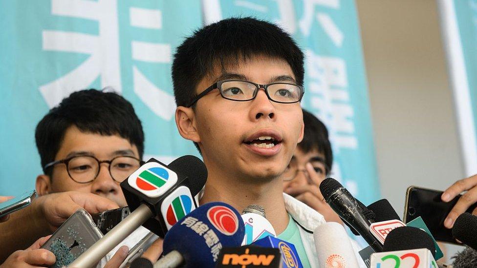 Pro-democracy political activist and a member of the Demosisto party, Joshua Wong, speaks to the media after leaving the Eastern Court