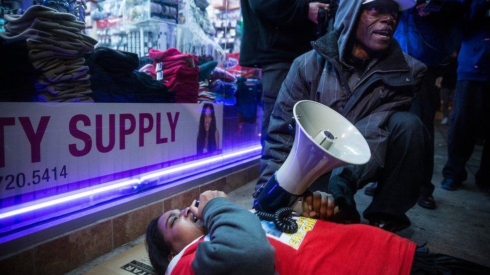 Erica Garner pictured lying on the floor, leading a demonstration march and "die in" event