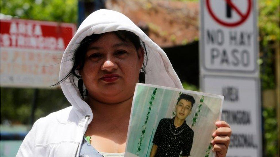 A relative of an imprisoned protester holds his portrait outside "El Chipote" prison in Managua, while demanding his release on July 18, 2018.