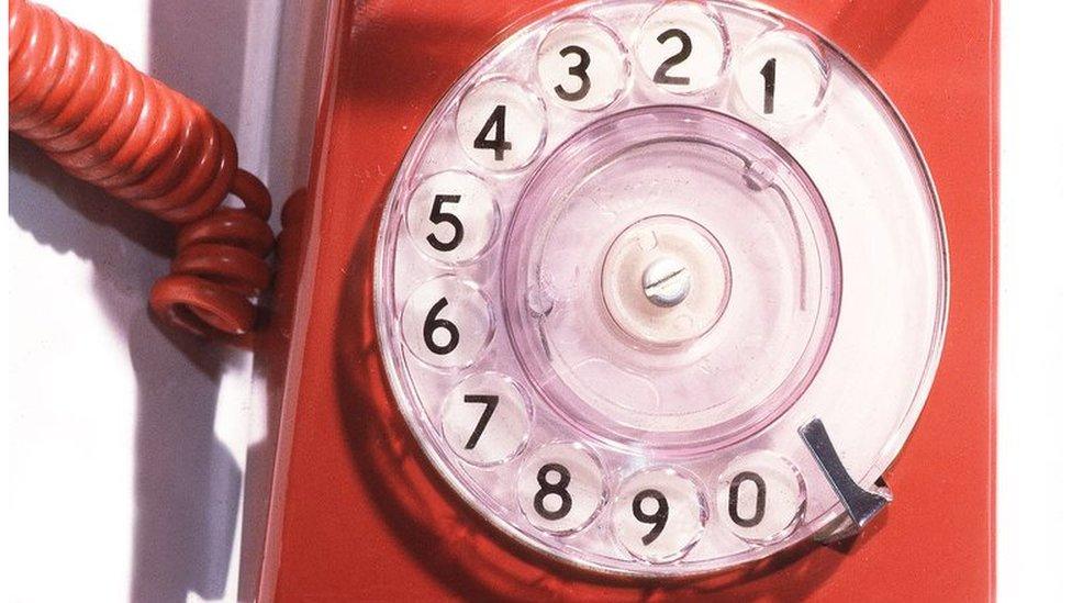 Old fashioned red phone with dial