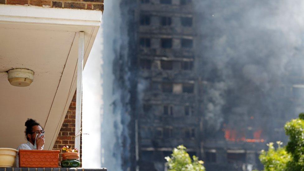 man in flat looking at fire