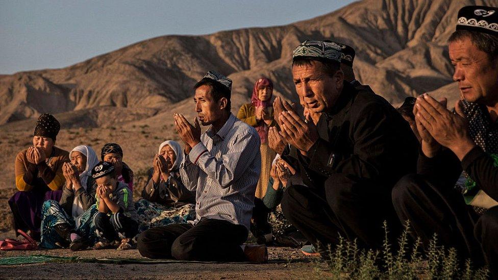 uyghurs praying together in xianjiang