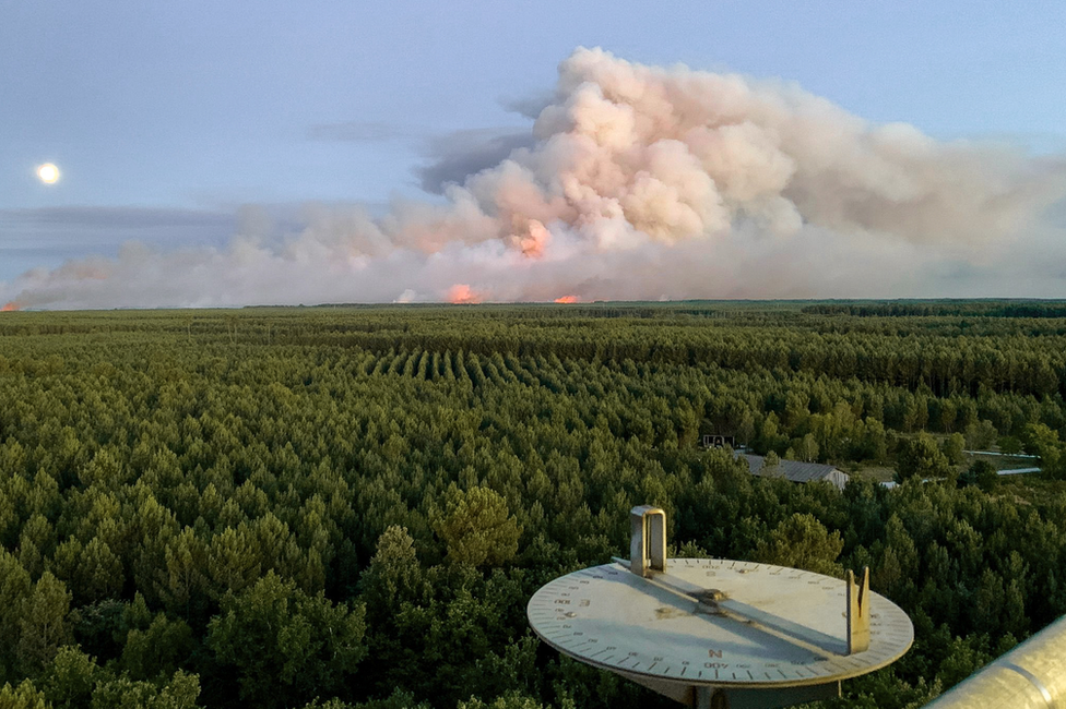 The July blaze, shortly after Escutia first spotted it. In the foreground, his alidade, for sighting fires