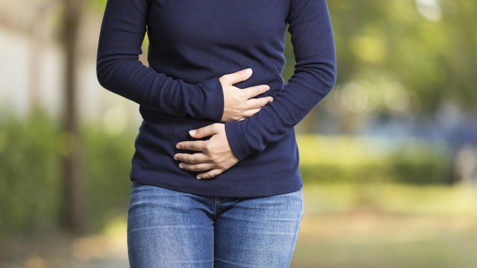 Woman holding her stomach