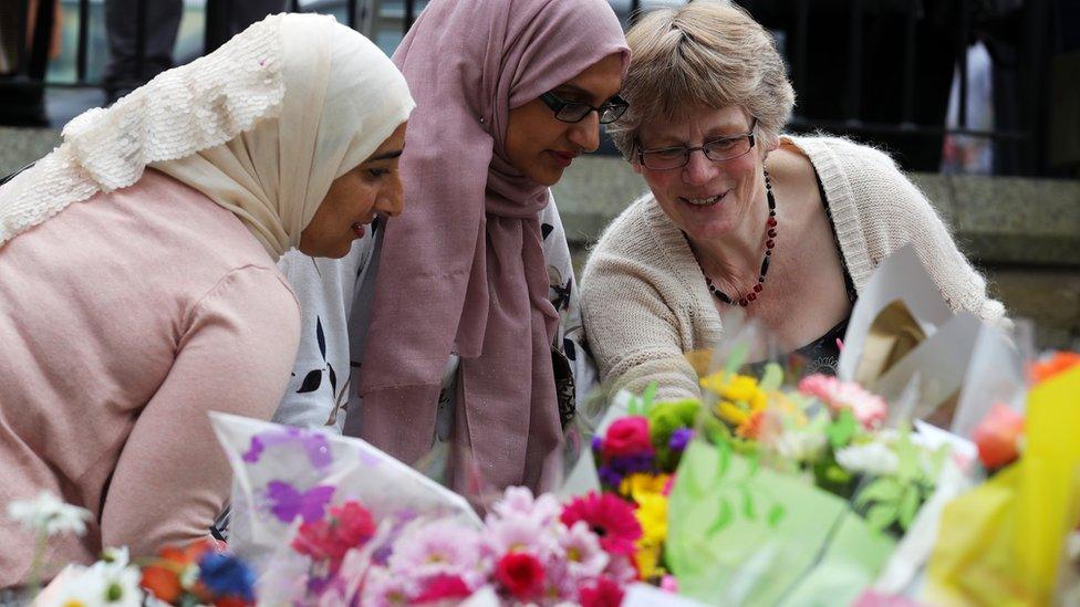 People lay floral tributes to Labour MP Jo Cox, at the base of a statue to Joseph Priestley in Birstall