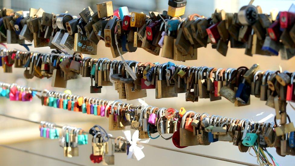 Padlocks on bridge