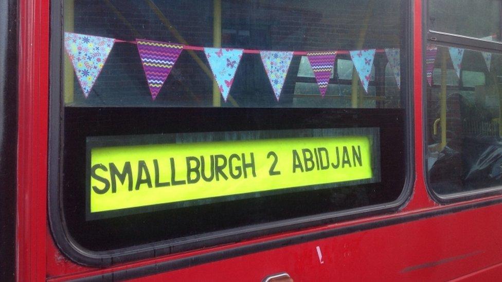 Bunting over sign for Smallburgh and Abidjan