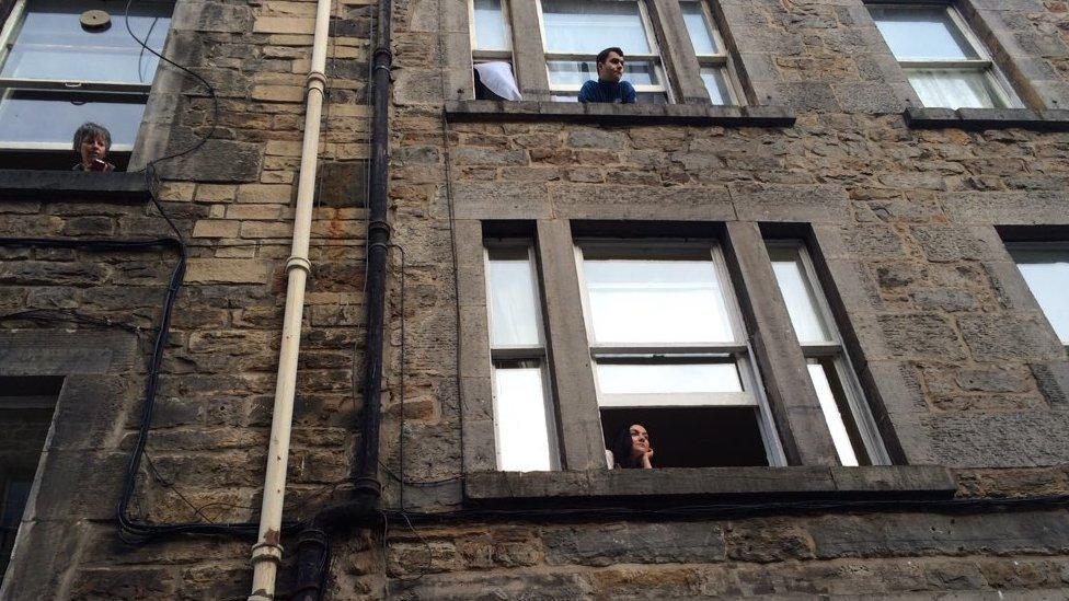 Locals hanging out of their windows had prime position for the Holywood visitor