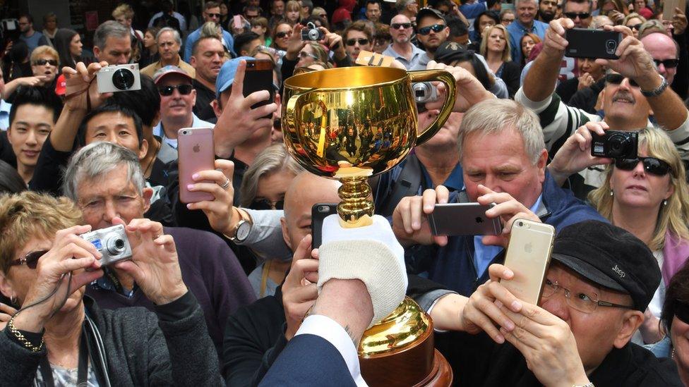 Melbourne Cup enthusiasts jockey to snap the prize at Monday's annual parade (1 Nov 2016)