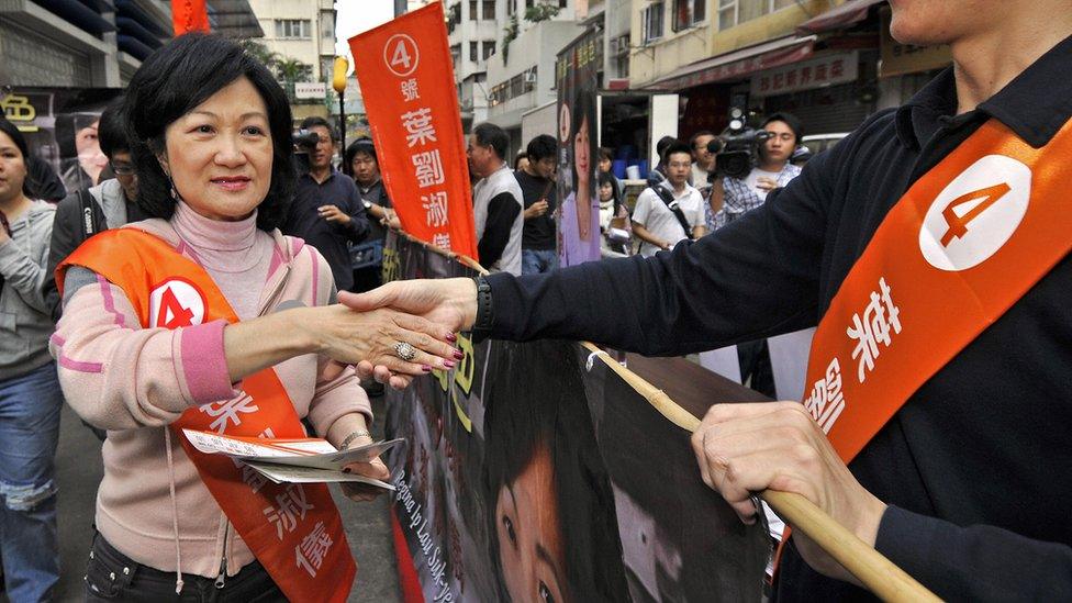 Hong Kong's former security secretary Regina Ip (L) canvasses for last minute votes for the territory's legislative by-elections in Hong Kong, 02 December 2007