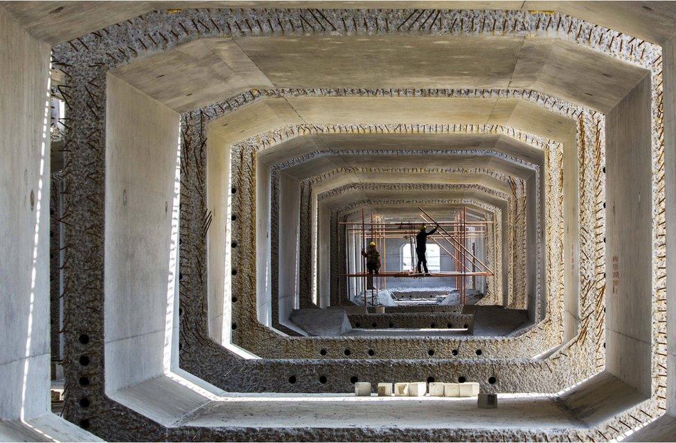 Labourers work at a railway bridge construction site in Lianyungang, Jiangsu province, China