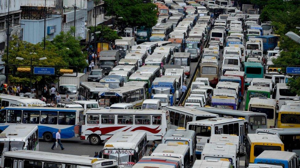 Drivers block a main avenue in Caracas during a protest due to the shortage of spare parts for their vehicles on 21 September