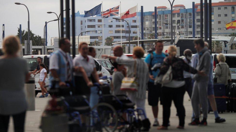 The European Union, the Union Jack, Gibraltarian and Spanish flags are seen flying, on Gibraltar's border with Spain on 27 June