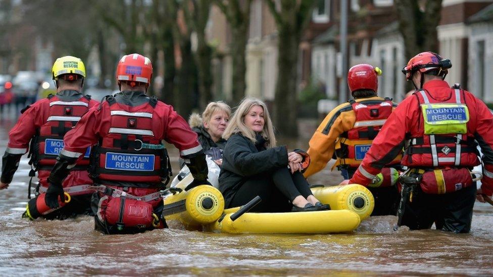 A rescue team evacuating people in Carlisle