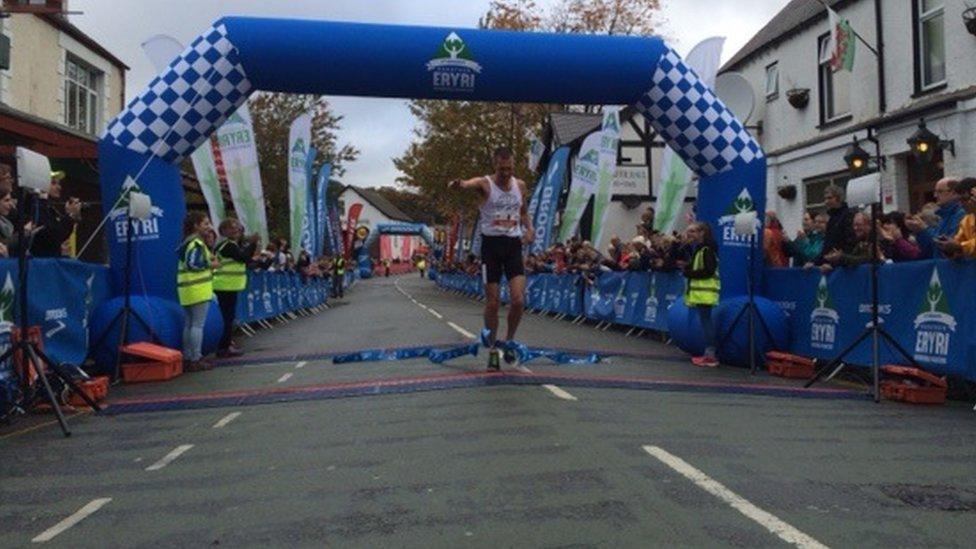 Russell Bentley crossing the finish line