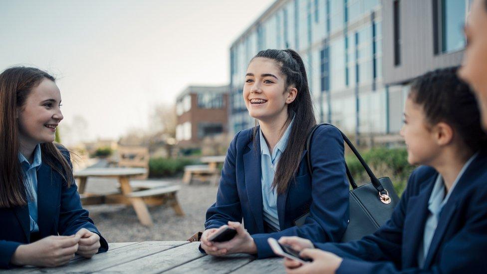 Schoolgirls sitting at a table