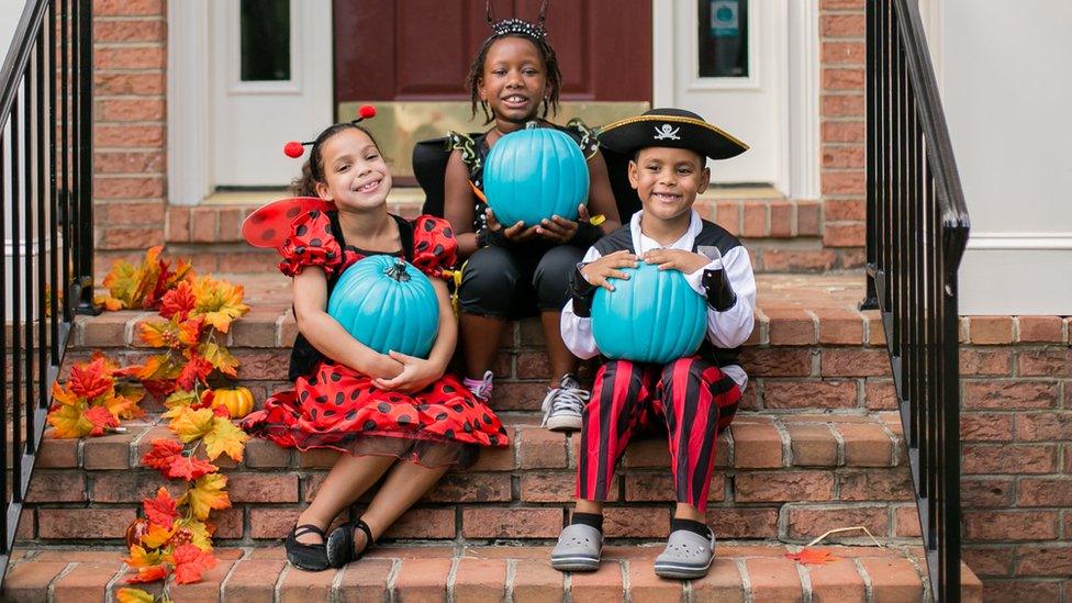 Kids with teal pumpkins