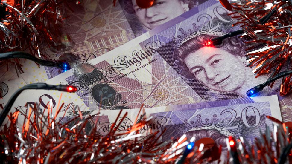 Money and christmas tinsel