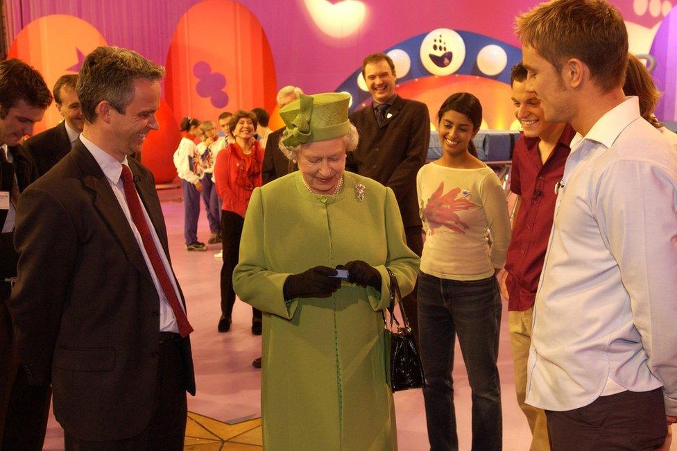 The Queen is presented with a Blue Peter badge