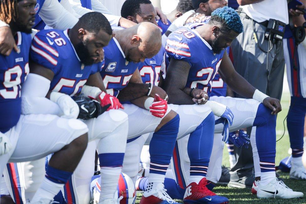 Buffalo Bills players kneel during the American National anthem before an NFL game against the Denver Broncos, 24 September 2017