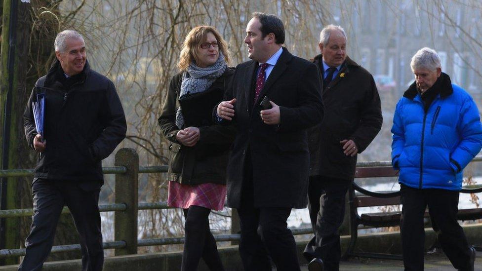 Paul Wheelhouse (centre) with councillors and council officials beside the River Teviot in Hawick