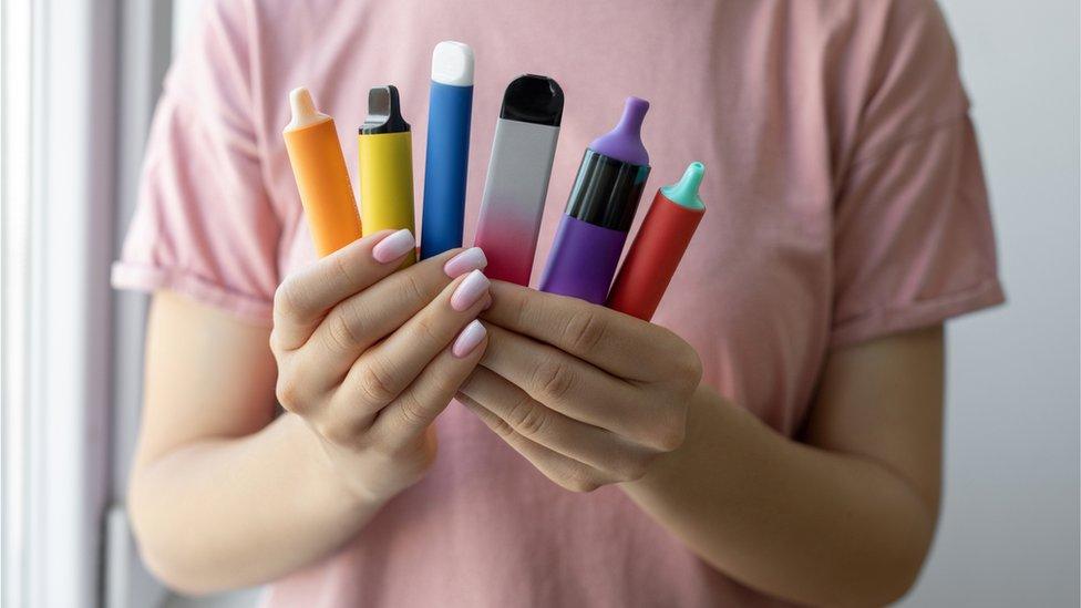 Disposable vapes in a woman's hand