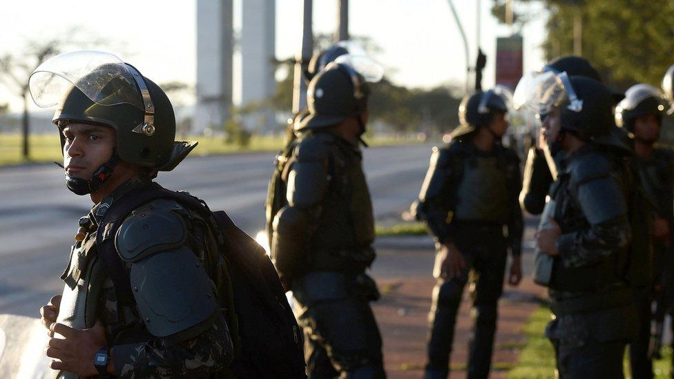 Brazilian Army military police in riot gear guard public buildings in Brasilia, on May 25, 2017