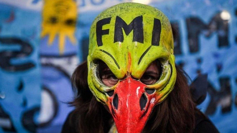 A woman demonstrates while legislators debate a bill to put a stop on public services taxes raising in Buenos Aires, on May 09, 2018.