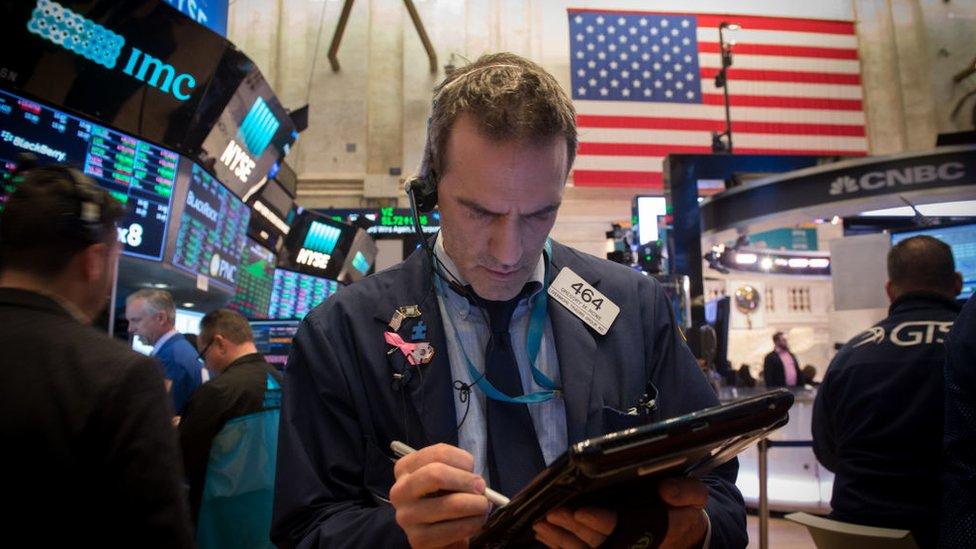 Traders work on the floor at the closing bell of the Dow Industrial Average at the New York Stock Exchange on January 17, 2018 in New York.