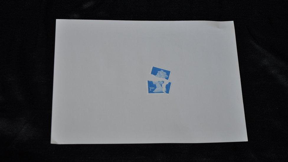 A 2nd class stamp ripped in half