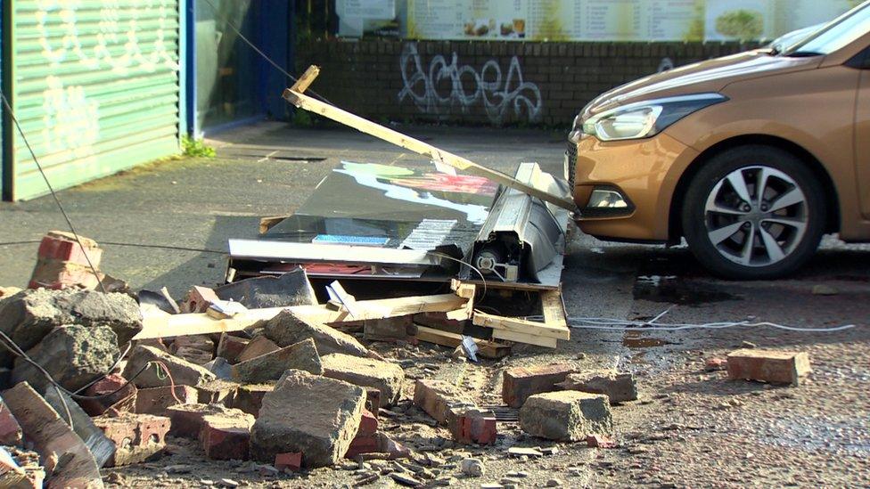 Rubble fell onto the pavement below the shops