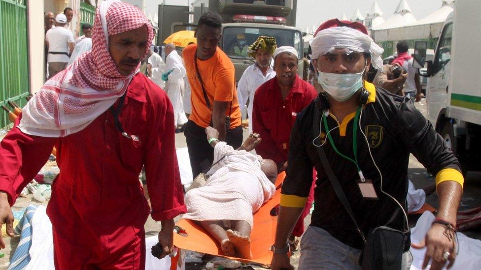 Saudi emergency personnel and Hajj pilgrims carry a wounded person in Mina, near the holy city of Mecca, at the annual hajj in Saudi Arabia on September 24, 2015