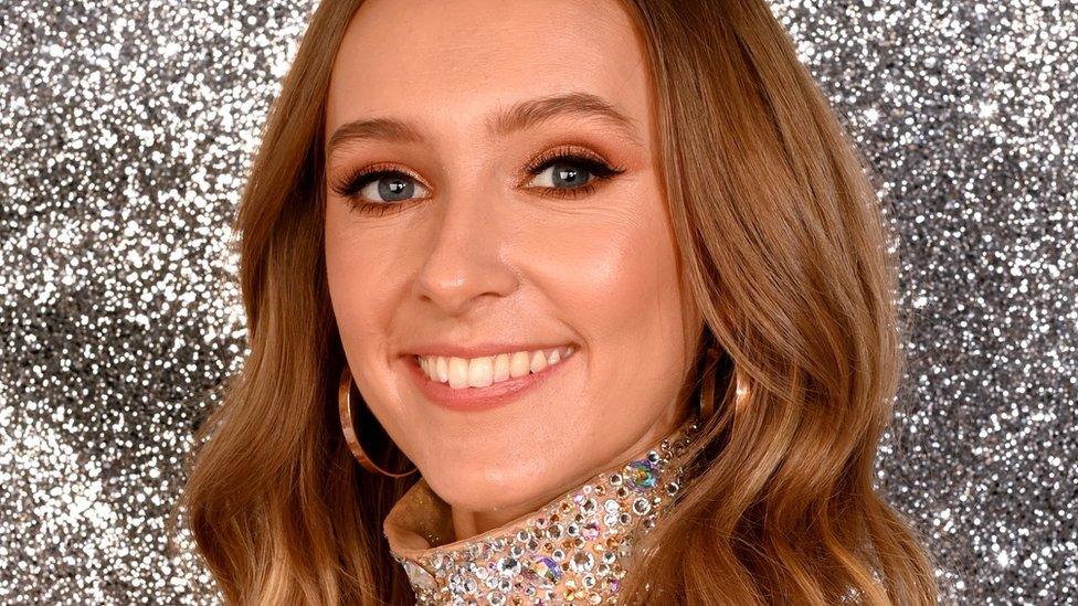 rose ayling ellis smiling at the camera wearing a sparkly dress