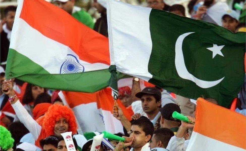 Indian and Pakistani cricket fans celebrate during the ICC Champions Trophy match between Pakistan and India on September 19, 2004 at Edgbaston in Birmingham, England