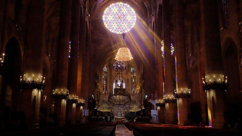 Bishop Sebastia Taltavull performs Mass at a deserted cathedral in Palma de Mallorca, Spain