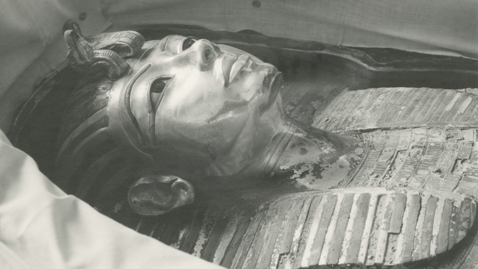 The iconic burial mask of Tutankhamun, in a black and white picture