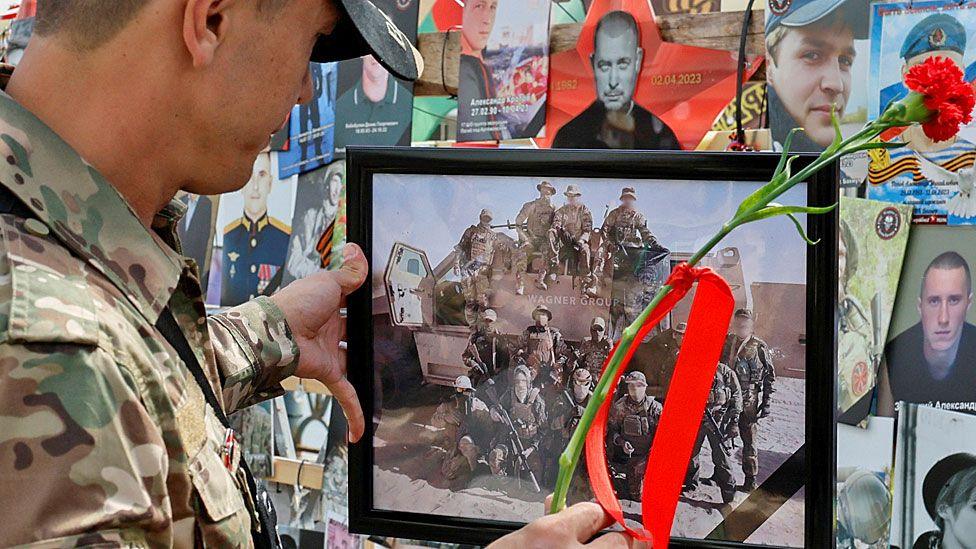 A man stands in front of a makeshift Wagner memorial in Moscow, first erected last year, during a commemoration ceremony held to pay tribute to Wagner fighters recently killed in Mali by northern Tuareg rebels - 4 August 2024