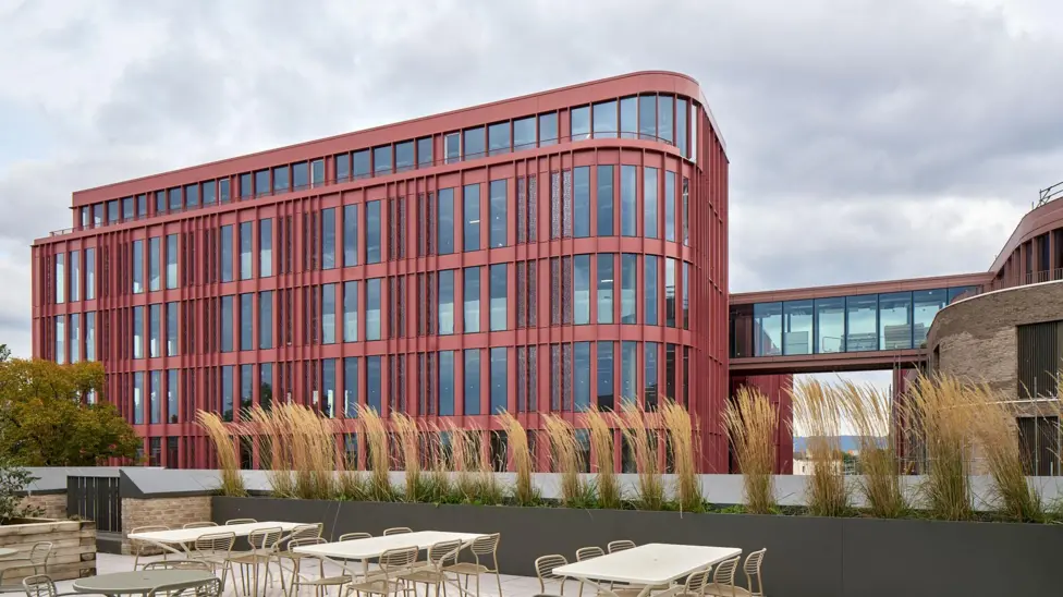 Computer image of what The Forum will look like -a red steel building with lots of windows and a connecting bridge 