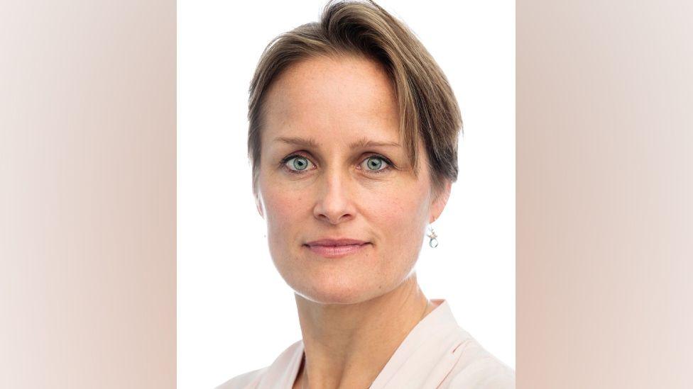 Frontal portrait of Blaise Metreweli. She is looking at the camera against a white background.