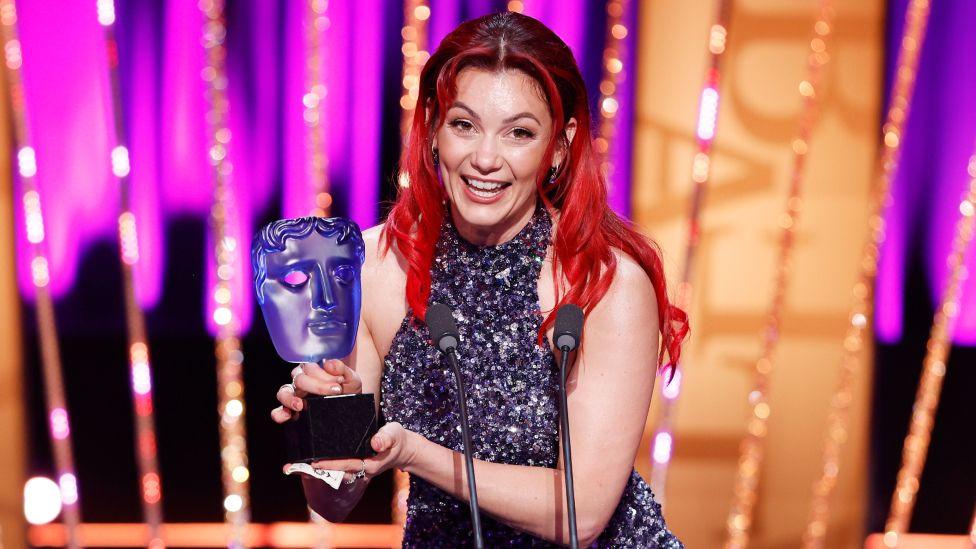 Dianne Buswell accepts the P&O Cruises Memorable Moment Award for 'Strictly Come Dancing' onstage during the 2025 BAFTA Television Awards with P&O Cruises Ceremony at The Royal Festival Hall on May 11, 2025 in London, England.