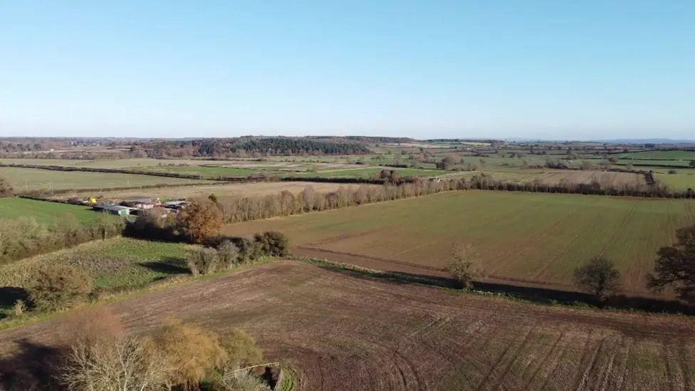 An airborne shot of a large, flat area of countryside