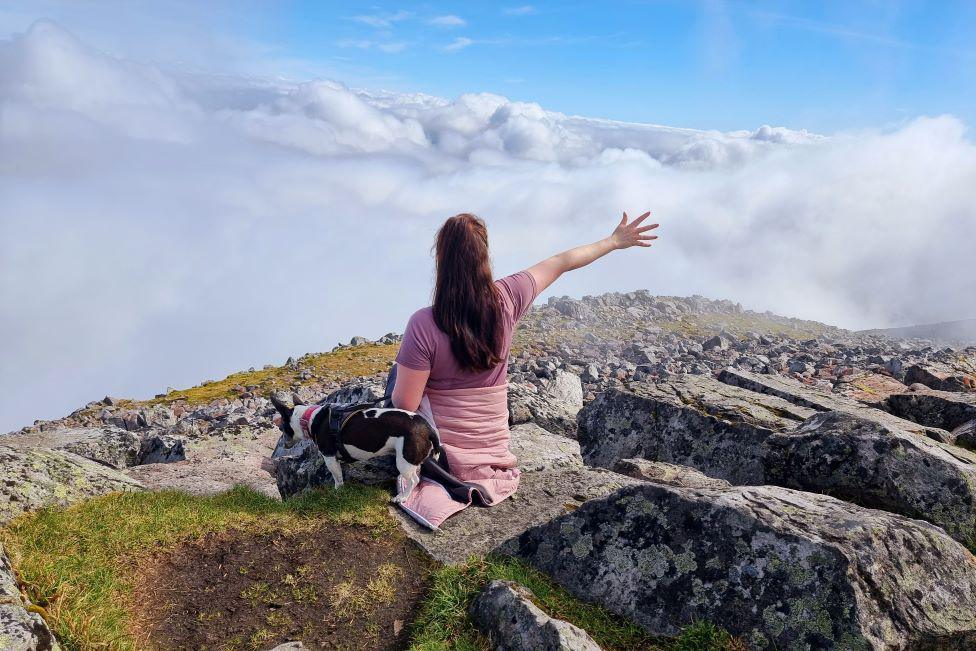 Woman and dog at top of Schiehallion