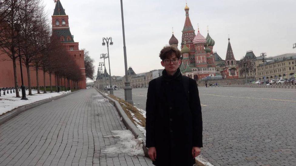 Kevin standing in Red Square in Moscow with the Kremlin wall on one side and St Basil's Cathedral behind him