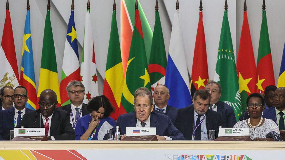 Russian Foreign Minister Sergei Lavrov reading a speech at a conference table surrounded by officials and Africa foreign minister - behind him are seen the flags of Russia and African countries - Sunday 10 November 2024